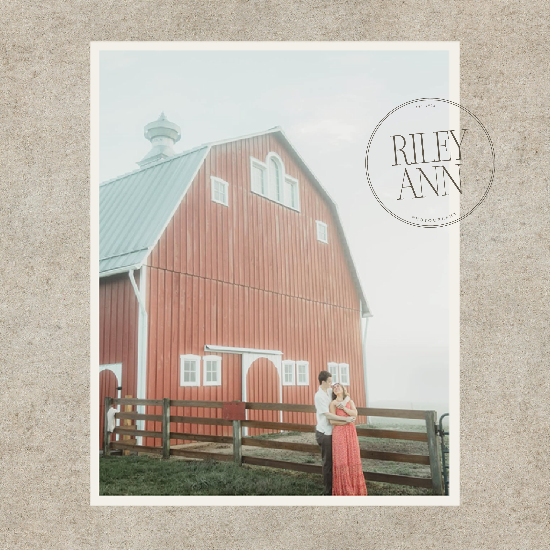couple standing in front of a red barn for Riley Ann photography branding