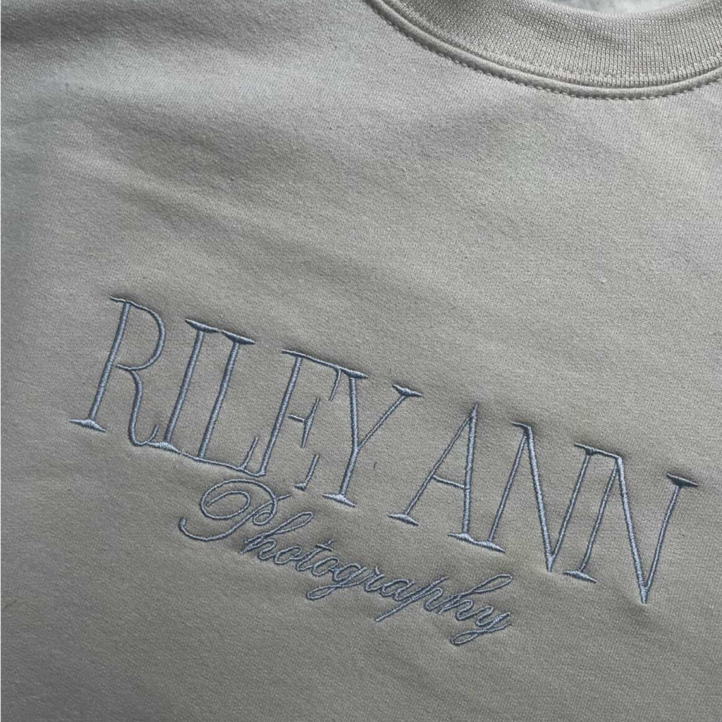 Embroidered Riley Ann Photography logo on fabric